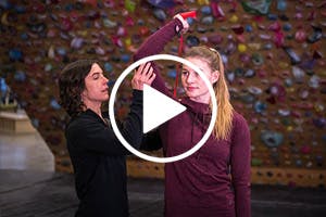 Thumbnail image for a video with Esther Smith and Claire Baurfeind in a climbing gym with a play button overlaid.