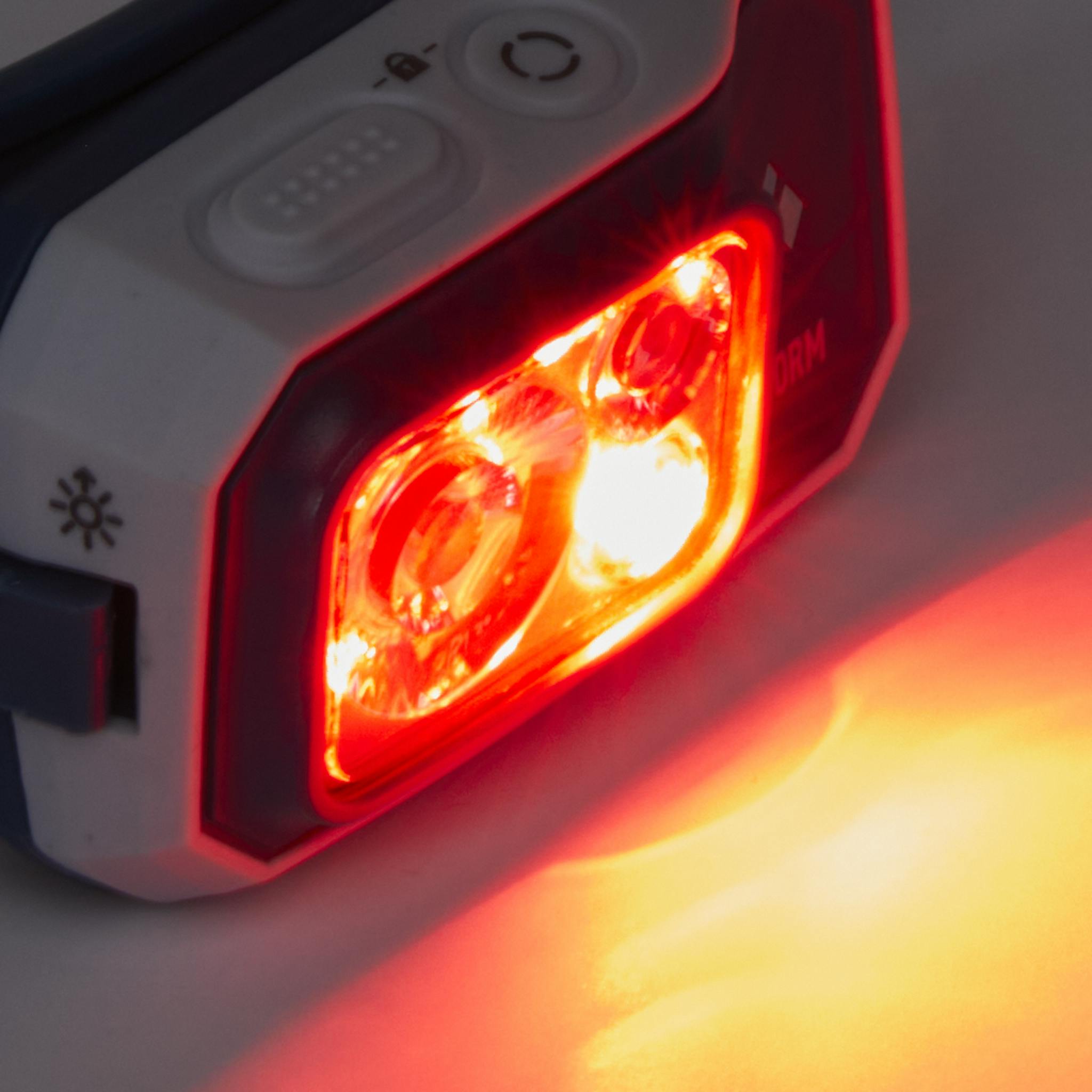 A close up of the Storm 450 Headlamp with the red LED on.