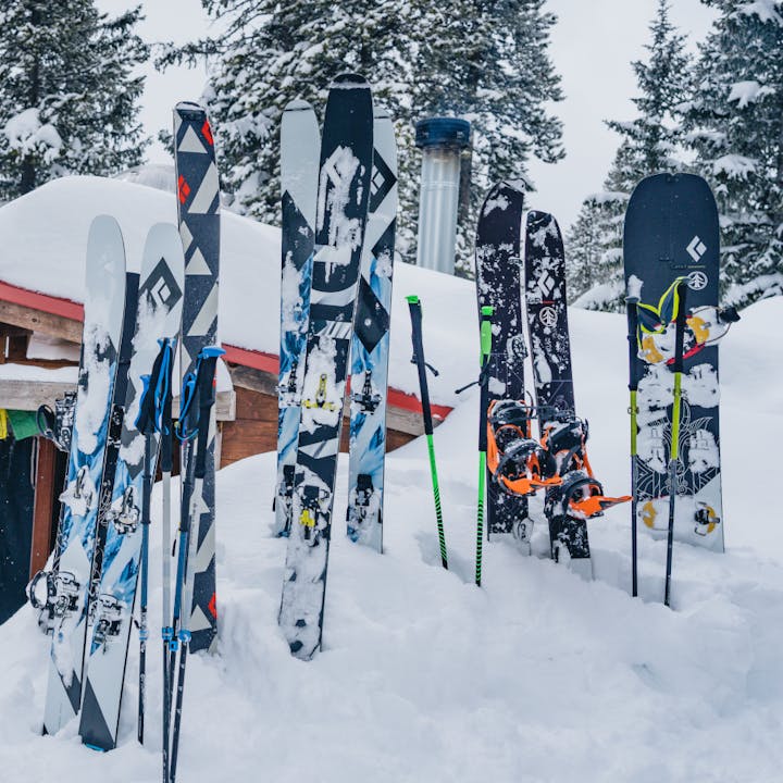The skis, ski poles, and splitboards wait outside a yurt for their riders to shred more of the endless powder in Utah. 