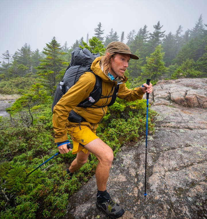 Stormline Rainwear. A through hiker using Black Diamond Distance Carbon Z Trekking poles. 
