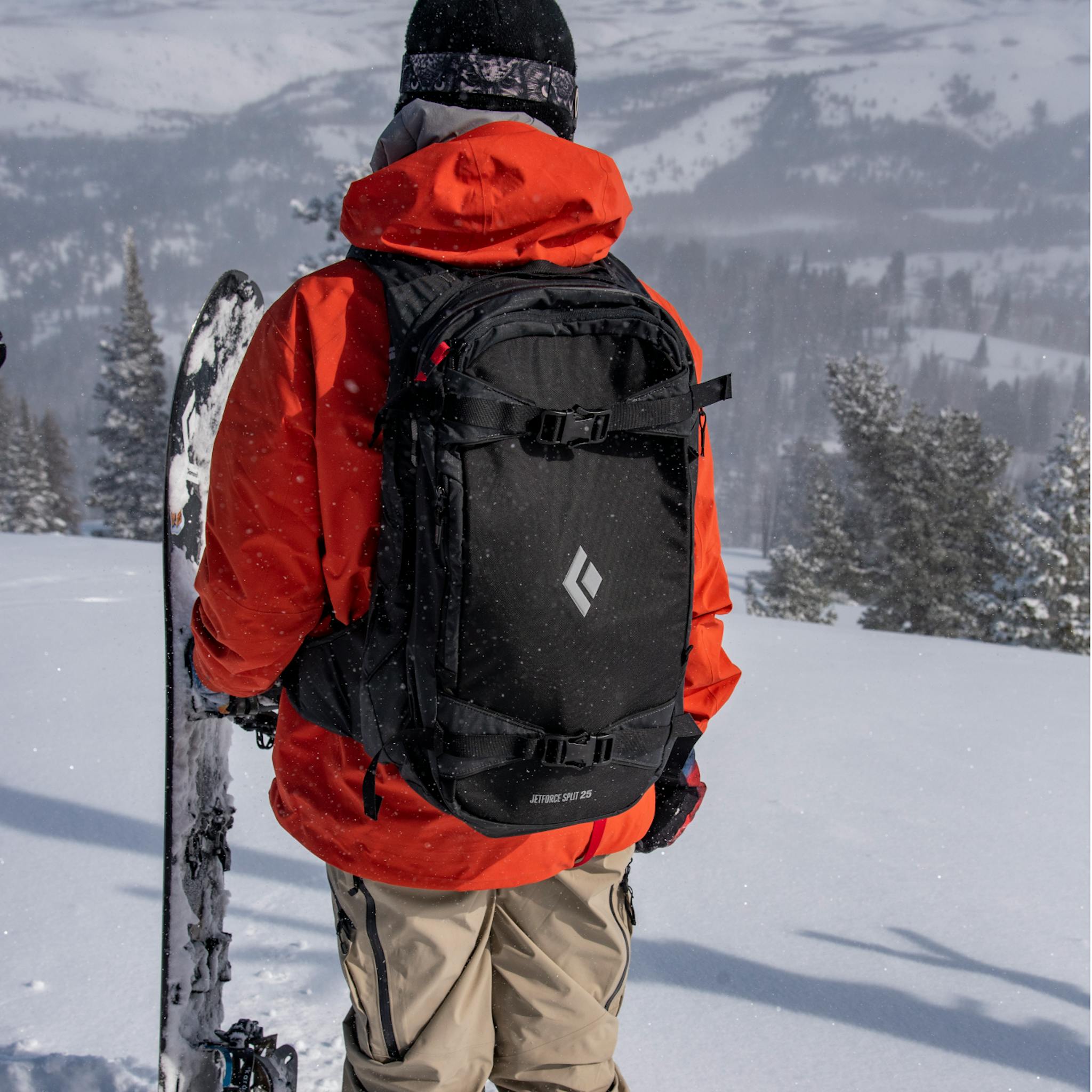 A snowboarder wearing a Jetforce Split packs looks over the horizon.