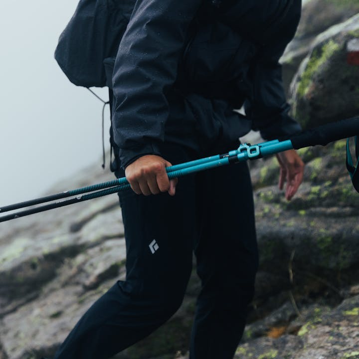 A hiker wearing Black Diamond pants on a foggy hike. 