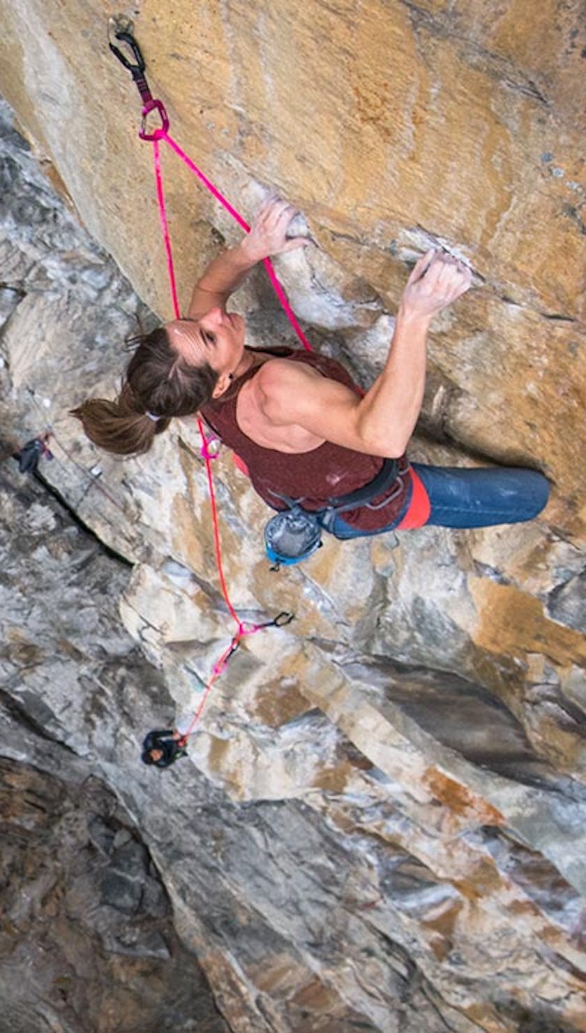 climber reaching for a hold on a route