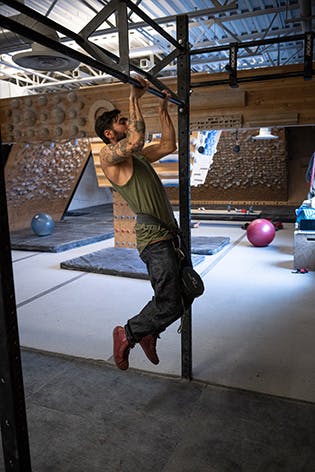 Sam Elias performing a weighted pull-up