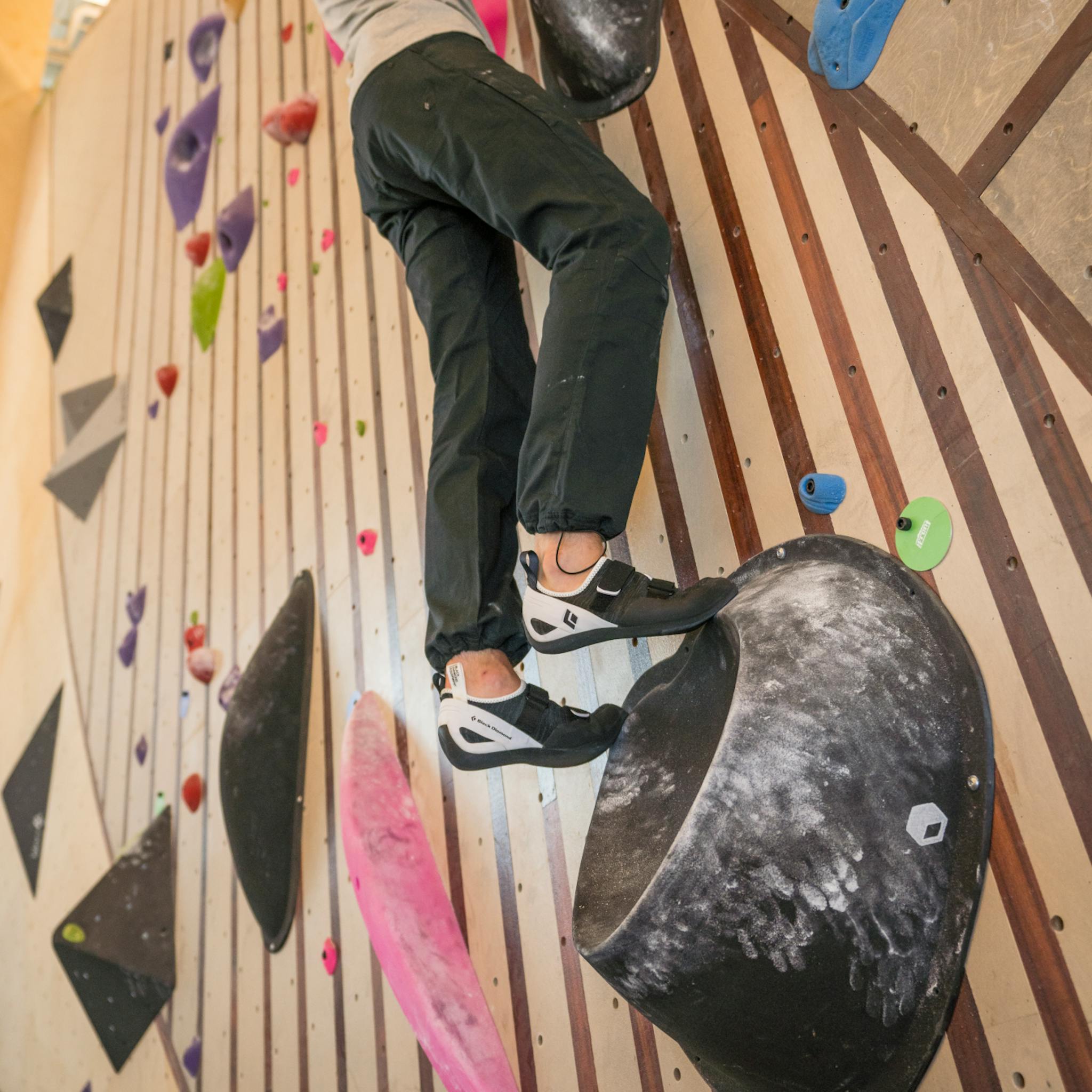A climber works his way up a gym slab in Momentum Climbing Shoes.