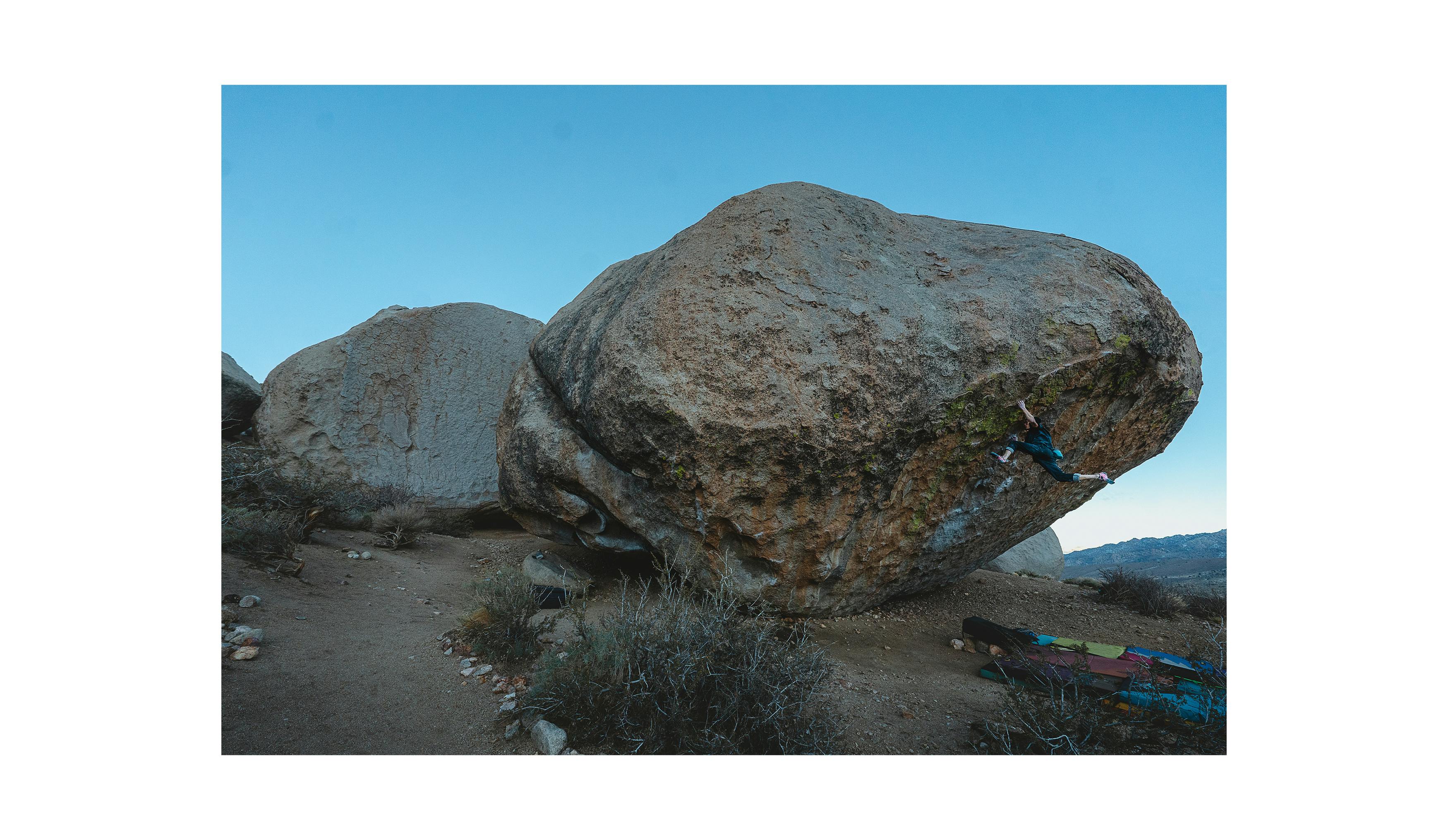Timmy Kang climbing on a highball boulder in Bishop.