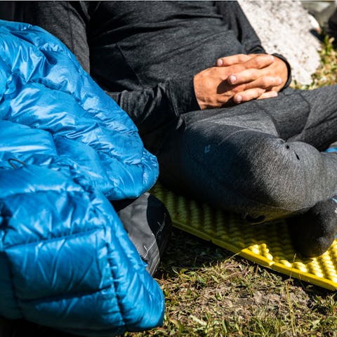 Climber basking in the warm alpine sun in his Black Diamond solution wool Base Layers. 