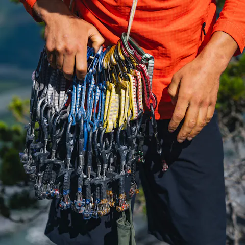 A climber with a large rack of Z4 cams.