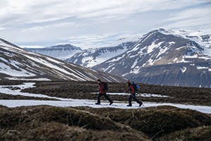 John and Eric Jackson walking in front of mountains in Iceland