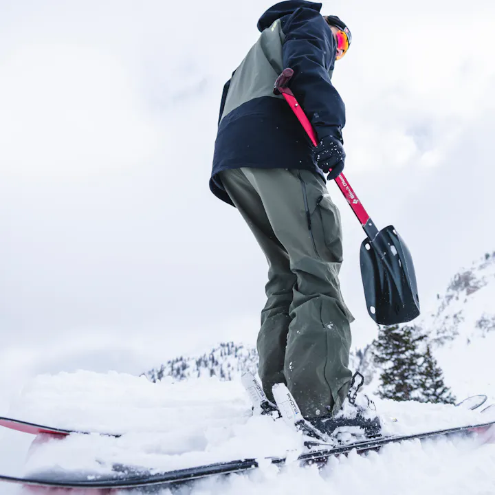 A skier preps a jump in the backcountry wearing Black Diamond Recon Collection.