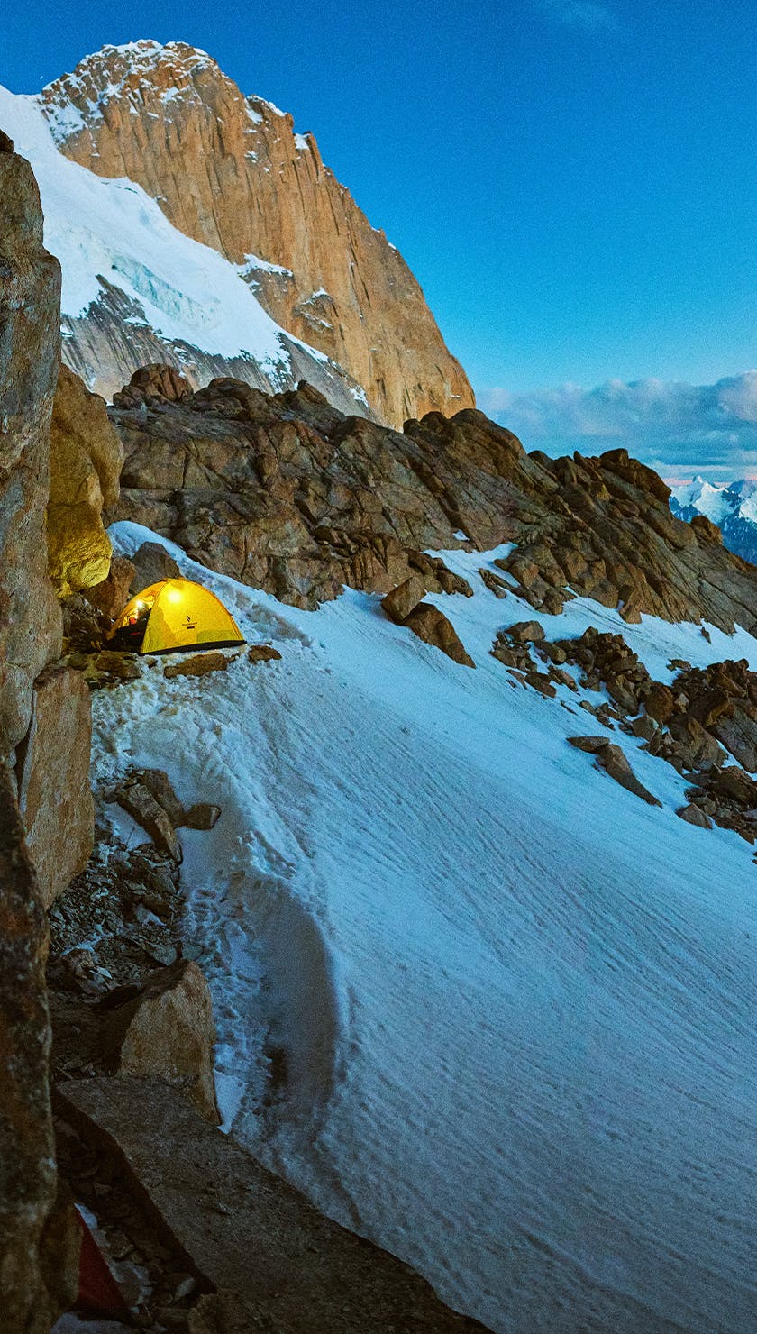 A Black Diamond tent perched on a bivy ledge high up in the mountains. 