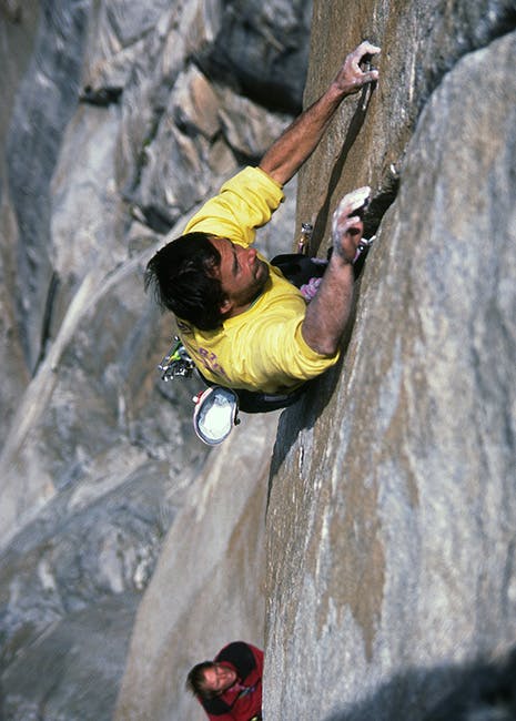 climber working his way up a crack on a route