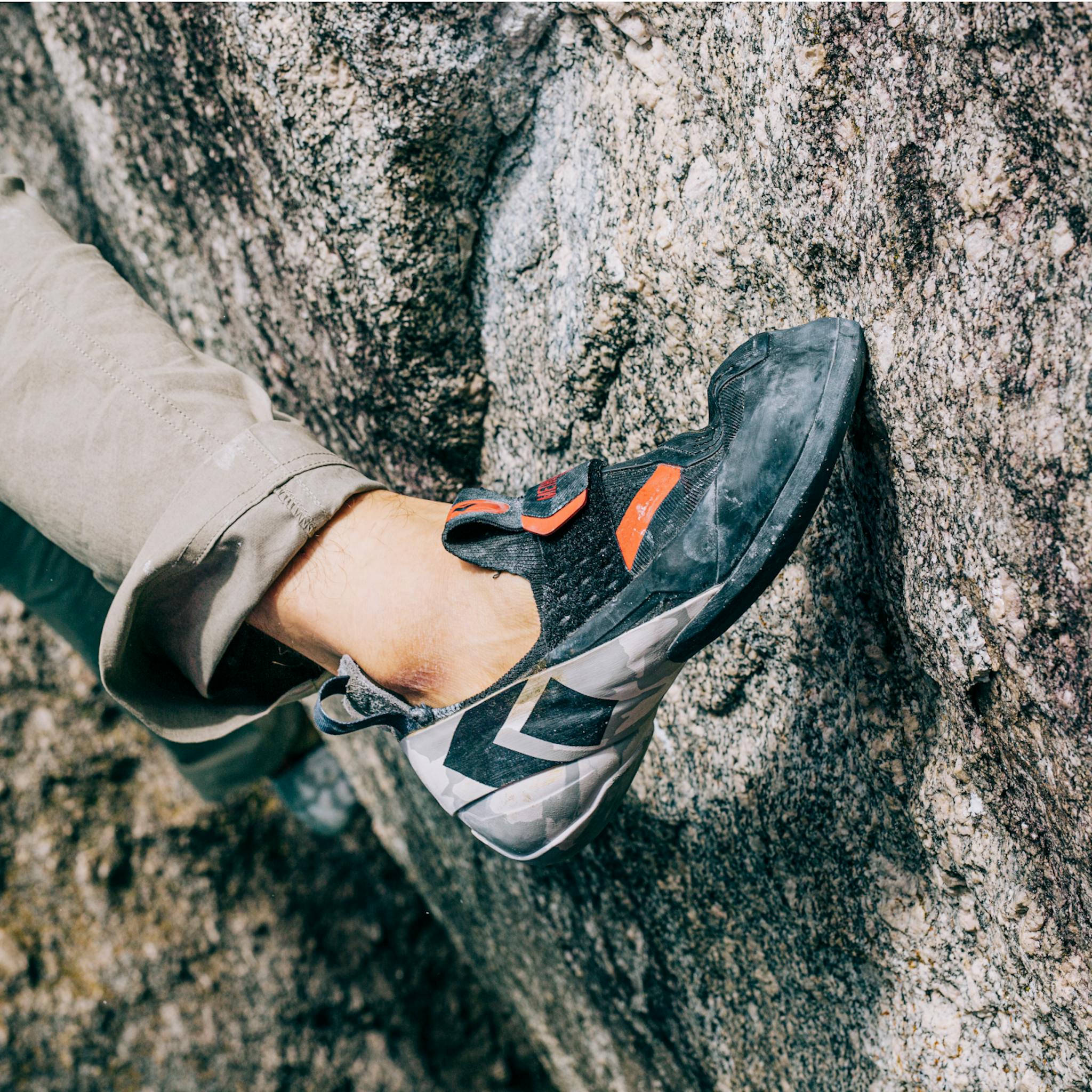 A climber smearing his Method S climbing shoe while bouldering.