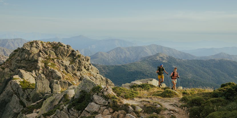 Two hikers move through the mountains with Beta Light Series Backpacks. 
