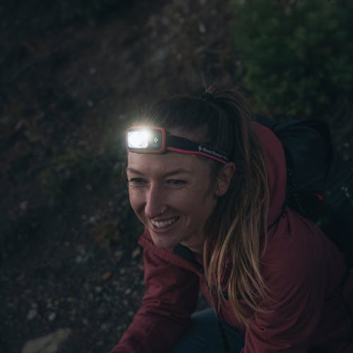 A hiker wearing the new Spot 400 Dual Fuel headlamp. 