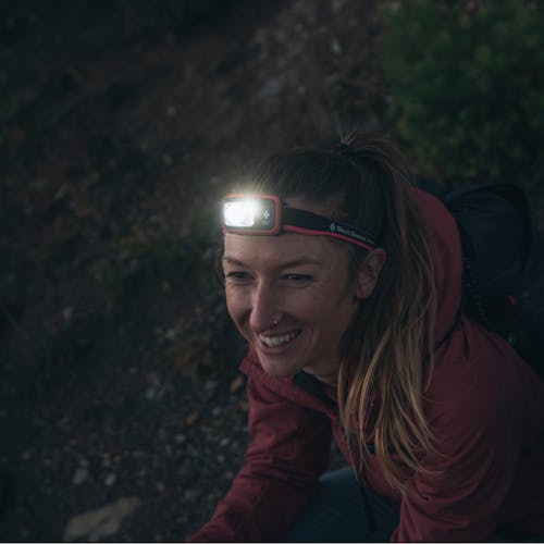 A hiker wearing the new Spot 400 Dual Fuel headlamp. 