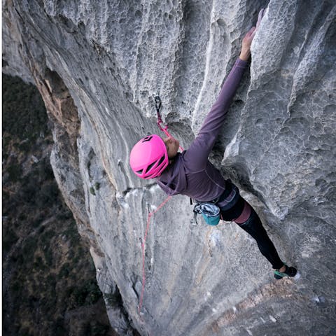 A female climber sport climbing at The Grail, Arizona. 