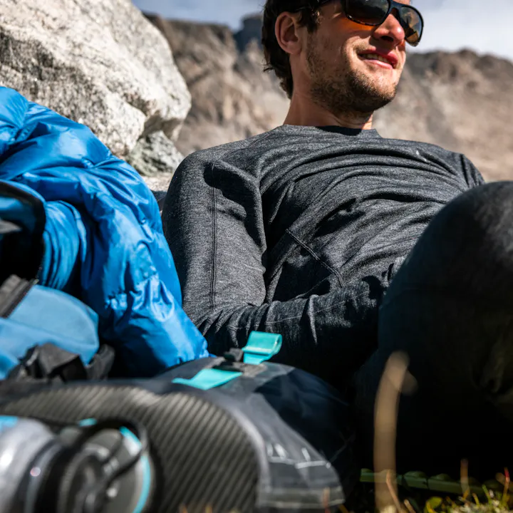 A hiker taking a rest in his Black Diamond base layers in the Wind River Range, WY. 
