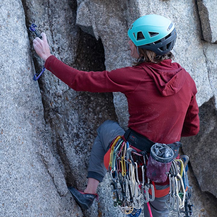 Climber places a Black Diamond Camelot for protection on a Wasatch classic. 