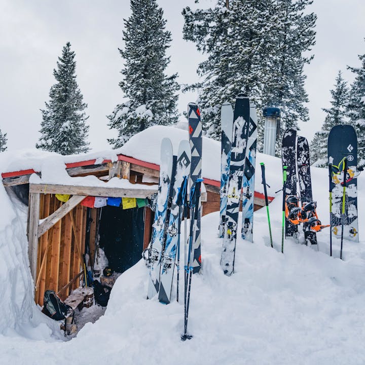 Black Diamond ski gear in front of a hut