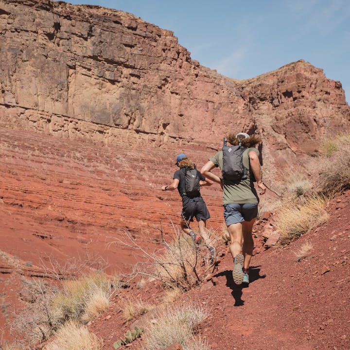 Two runners with Black Diamond running packs in the desert. 