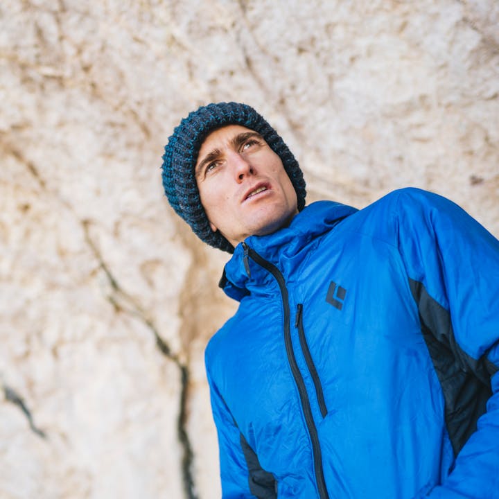 Seb Bouin at the base of a climb in a Vision Hybrid Hoody. 
