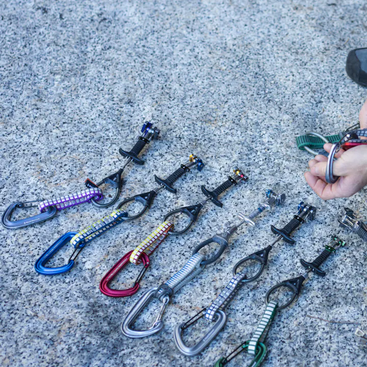 Black Diamond Z4 cams and carabiners lined up on a rock. 