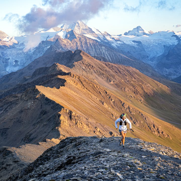 A trail runner running through the Alps with the BD Distance Collection. 