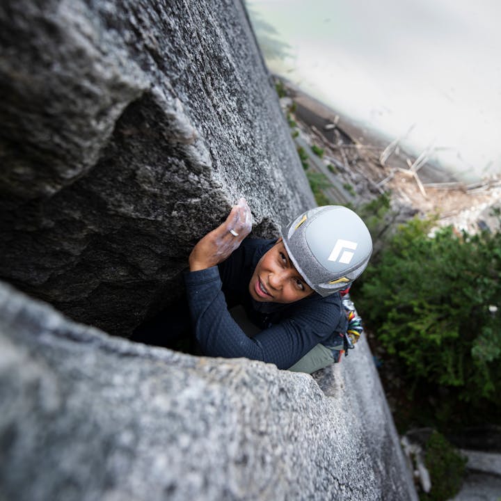 A climber wearing a Vapor helmet deep in a granite chimney. 