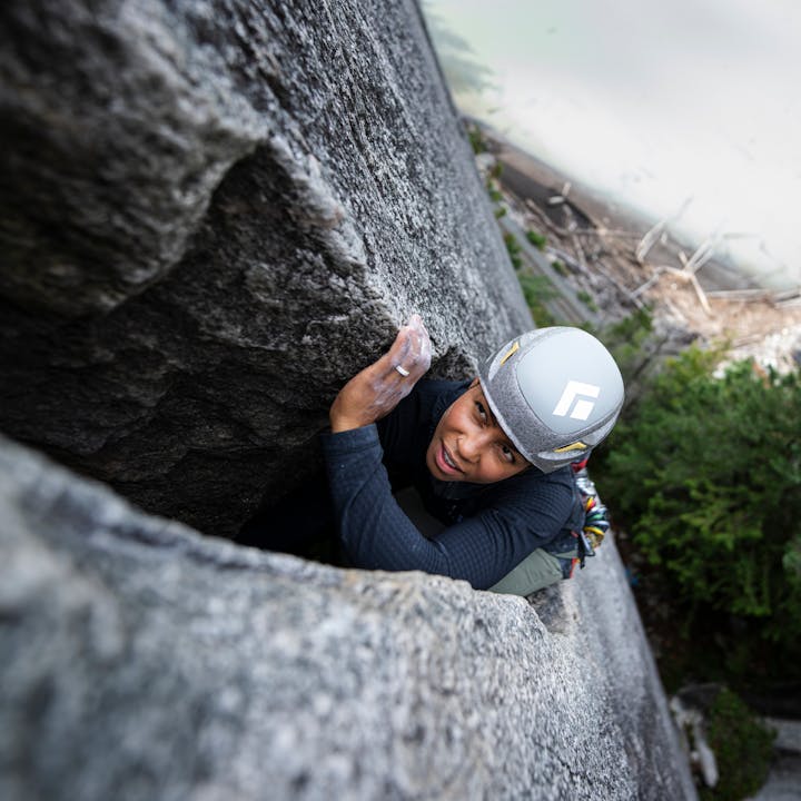 A climber wearing a Vapor helmet deep in a granite chimney. 