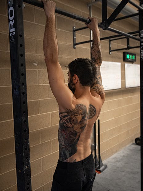 Sam Elias hanging from pull-up bar