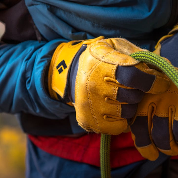 A climber belays in Black Diamond Transition Gloves. 