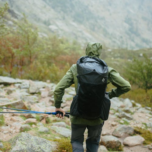 A backpacker pushes on through a rainstorm with the Beta Light 45 Pack.