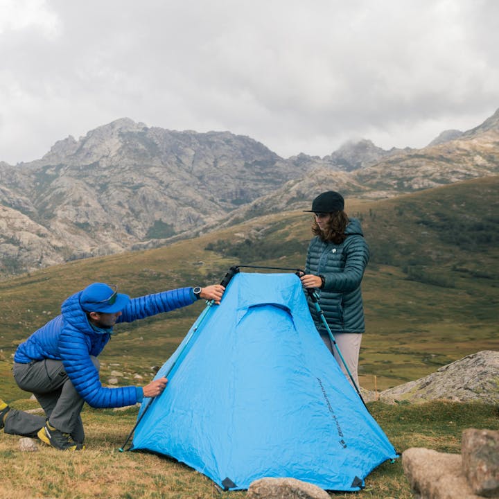 Two hikers set up their Beta Light tent in the Alps. 