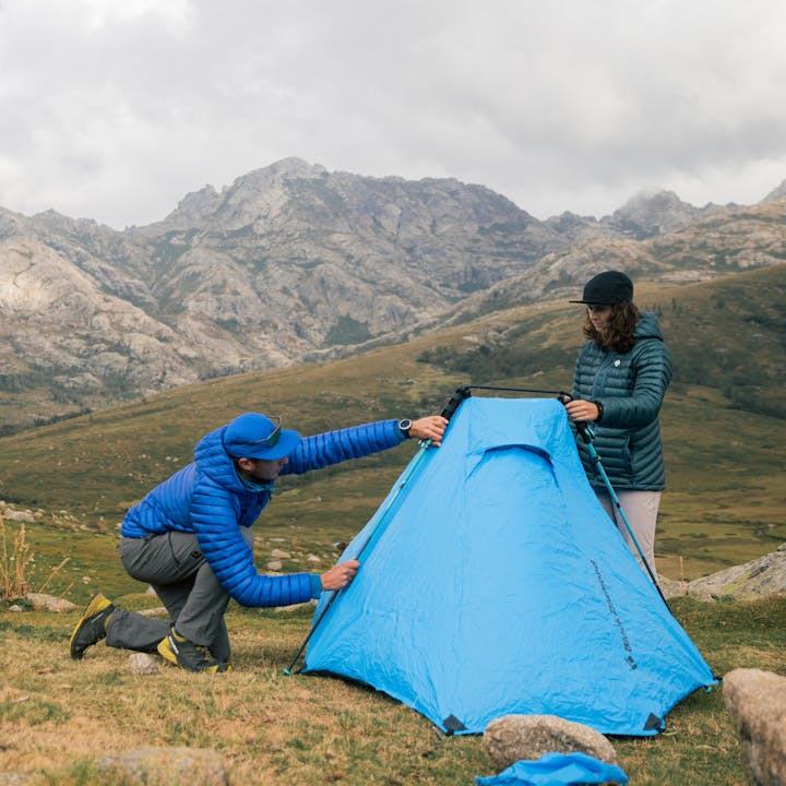 Two hikers set up their Beta Light tent in the Alps. 