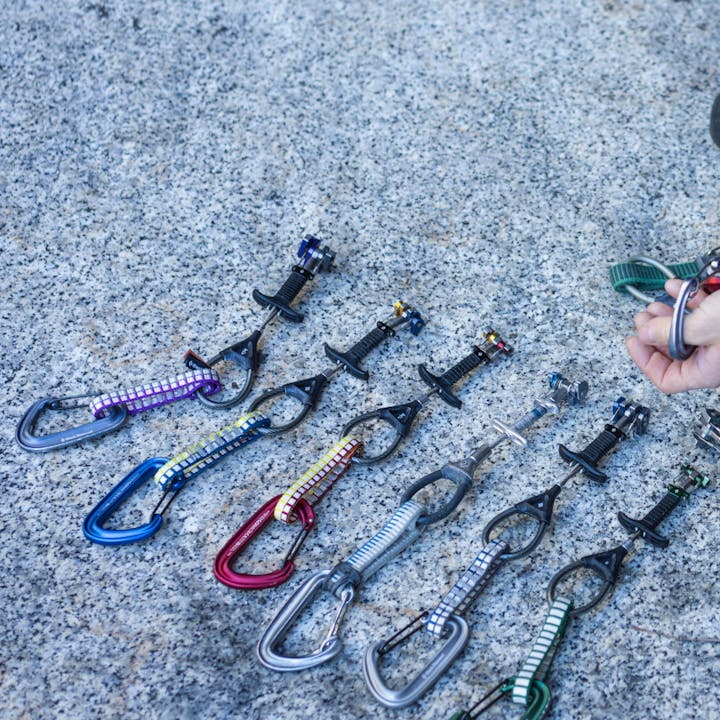 Black Diamond Z4 cams and carabiners lined up on a rock. 