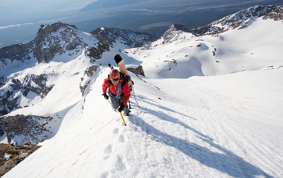Exum guide on snowy mountain ridge