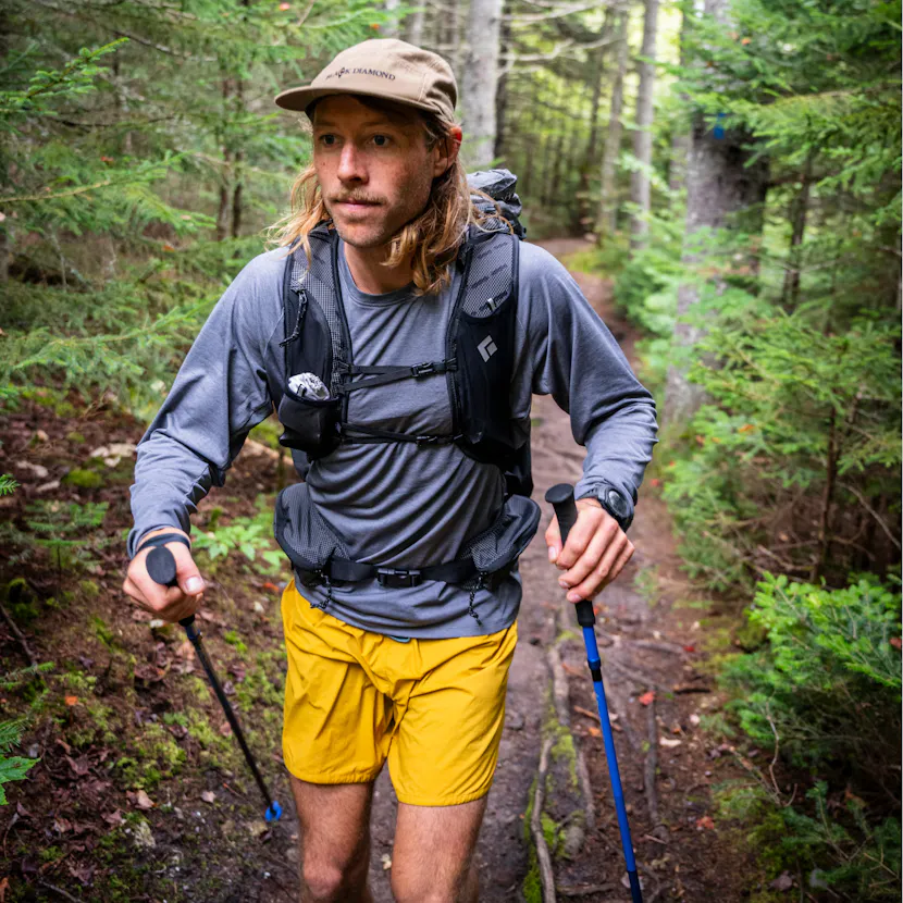 A hiker moves on the trail with the Beta Light Series Backpack. 