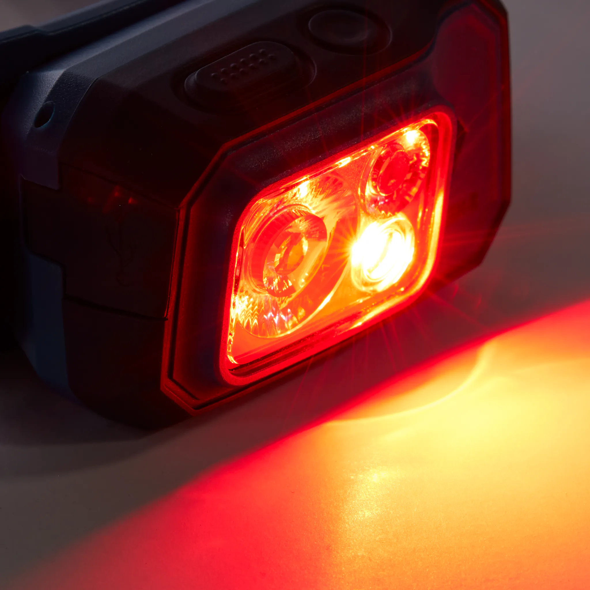 The Storm 500 R Rechargeable Headlamp with the red LED on.
