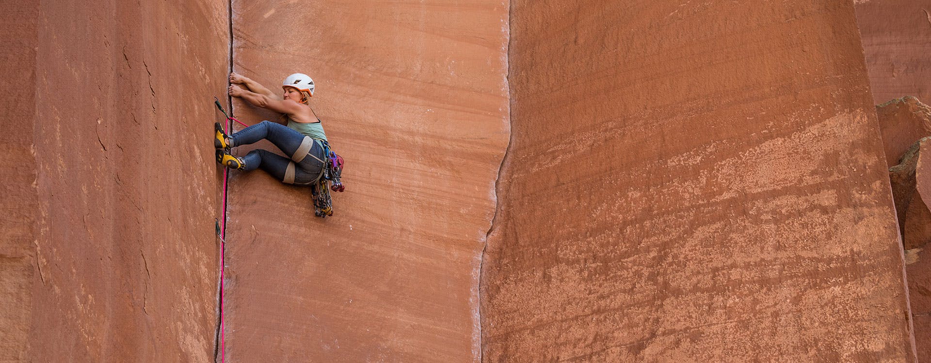 climber working her way up a crack