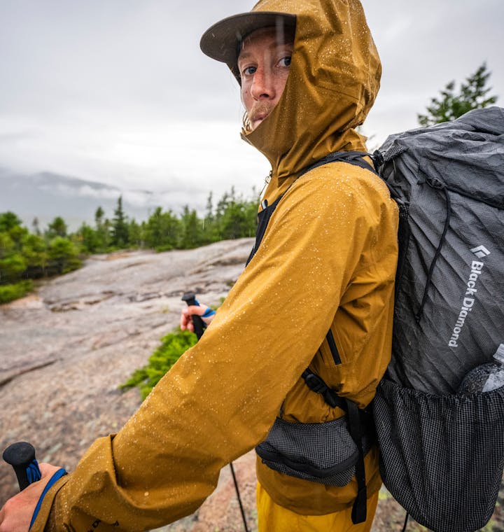 Men's Performance Rainwear. A hiker wearing the Stormline Stretch Rainshell. 