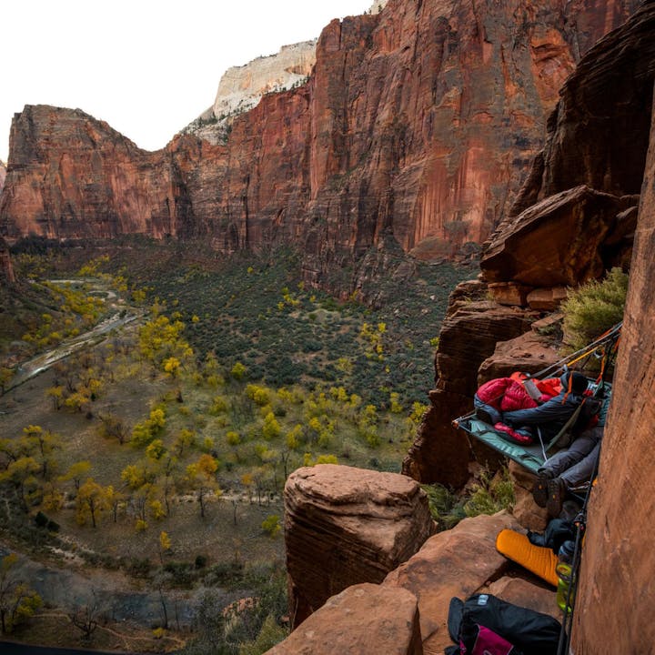 Photograph by Andy Earl of man on a portaledge overlooking Zion Valley