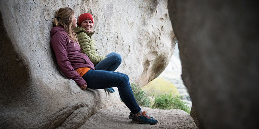 two climbers talking at the base of a crag