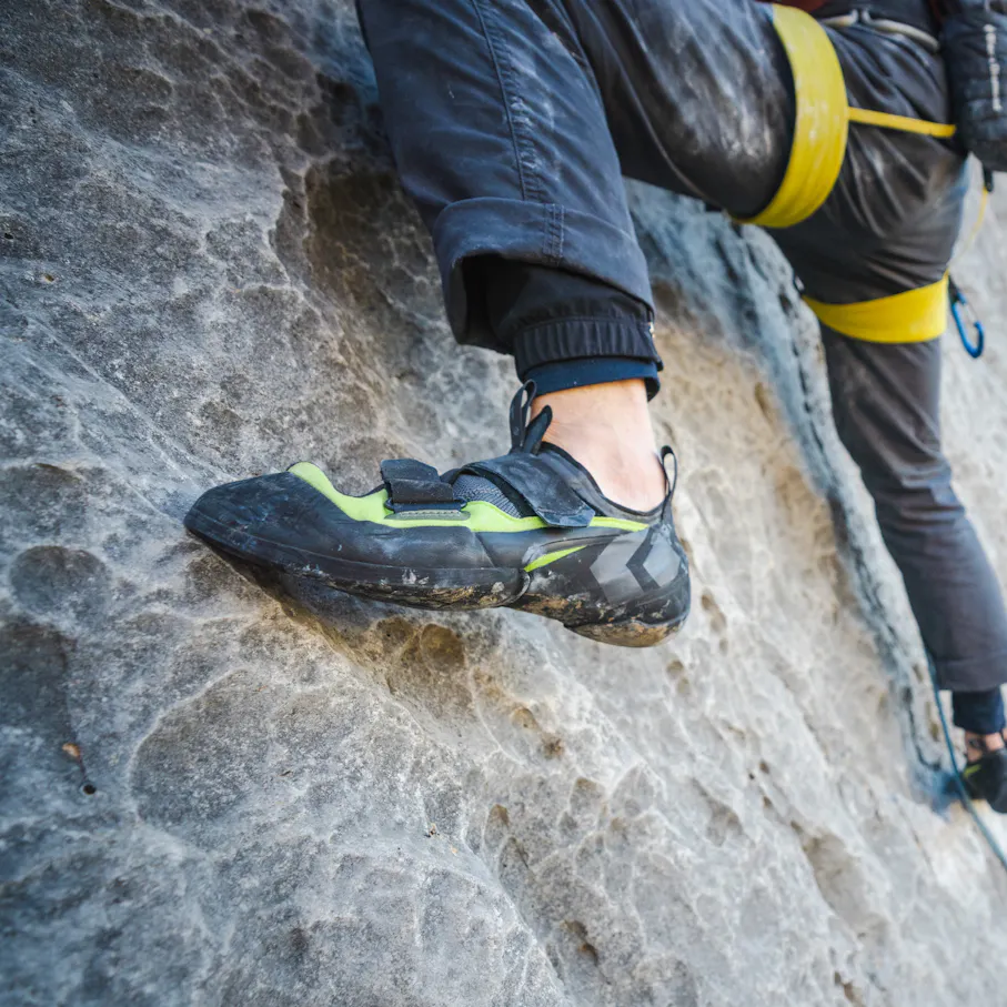 A climber steps out on limestone wearing Method Climbing Shoes