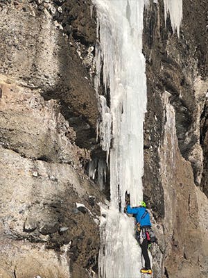 Photograph by Kolin Powick of Doug Chabot ice climbing in Montana