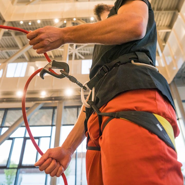 A climber belays in the gym using the Black Diamond ATC Pilot. 