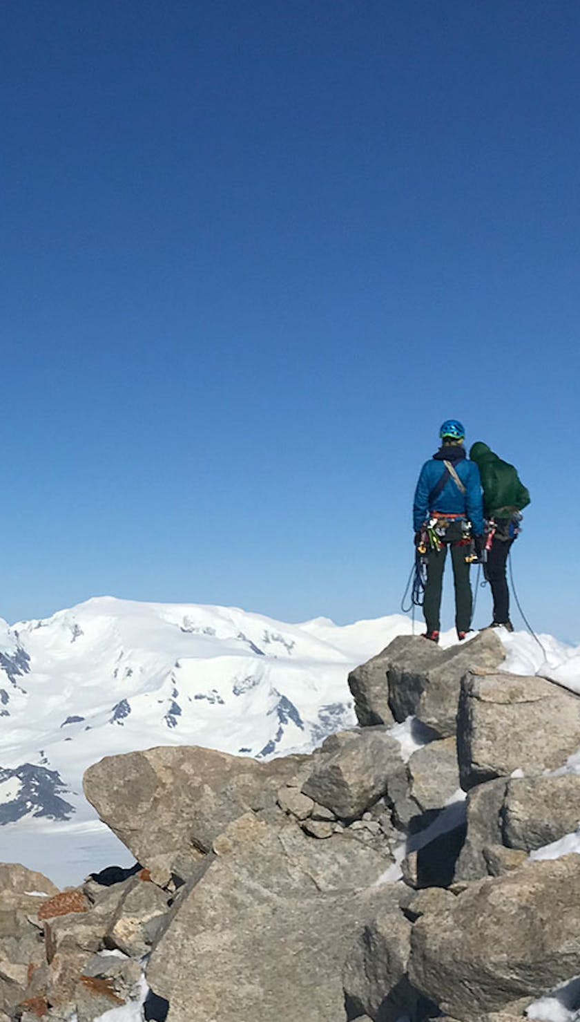 Climbers atop mountains  