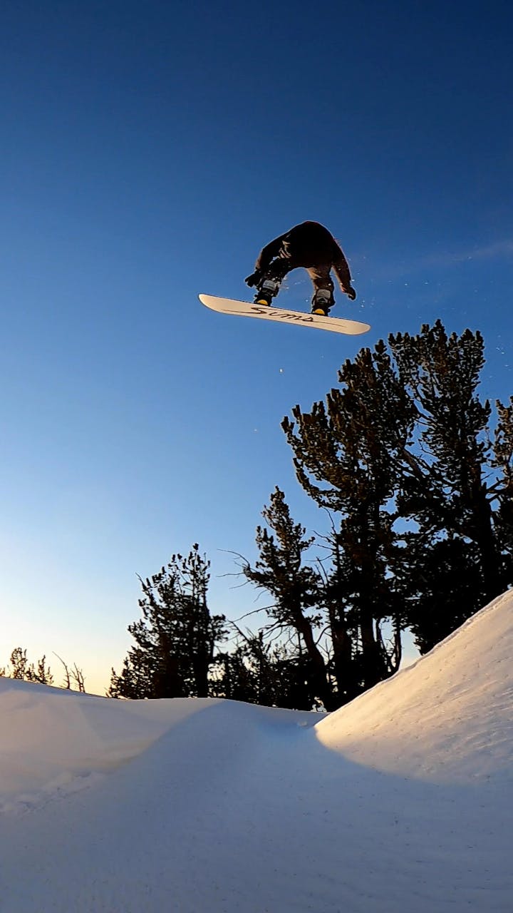 John Jackson hitting a jump on his snowboard
