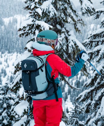 A backcountry skier wearing the Dawn Patrol 25 ski pack. 
