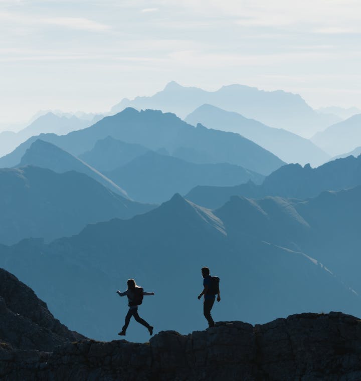 Hiking. Two Hikers moving through the mountains.